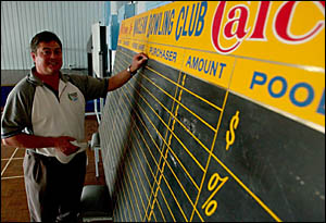 Iain Wills with the calcutta board for the Maclean Cup. Iain Wills with the calcutta board for the Maclean Cup.