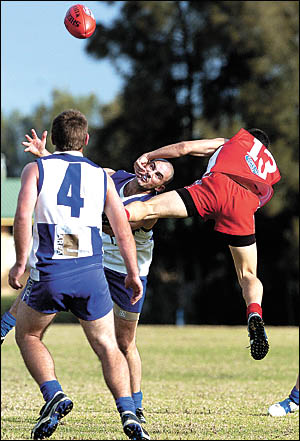 North Coffs players Josh Drum and Matthew Crispe vie for the ball with Coffs Swans player Nick Butcher during the AFL clash at North Coffs players Josh Drum and Matthew Crispe vie for the ball with Coffs Swans player Nick Butcher during the AFL clash at