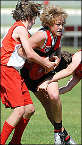 Sawtell?s Jack Gillingham runs into trouble in the Saints v Coffs Swans under 14 grand final. Sawtell?s Jack Gillingham runs into trouble in the Saints v Coffs Swans under 14 grand final.