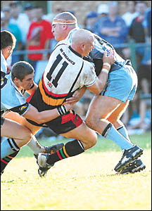 Coaches collide ? Craig Wallace is taken head on by John Cross. Coaches collide ? Craig Wallace is taken head on by John Cross.