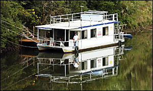 HOME IS WHERE THE WATER IS: Joris de Boer on his houseboat moored outside his property on the Wilsons River in North Lismore. P HOME IS WHERE THE WATER IS: Joris de Boer on his houseboat moored outside his property on the Wilsons River in North Lismore. P
