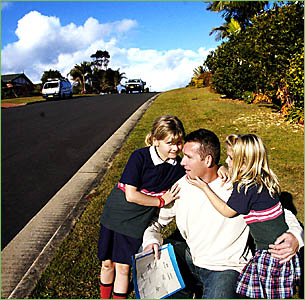 BUS BLUES: Mark Waller with his two daughters, Jasmine, eight and Emily, five, where their school bus picks them up in the morn BUS BLUES: Mark Waller with his two daughters, Jasmine, eight and Emily, five, where their school bus picks them up in the morn