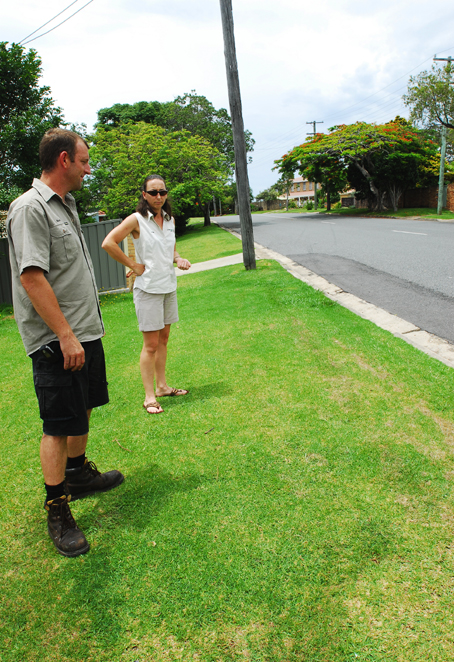 Close call . . . Louise Williams and Mark Herring in their front yard yesterday. TREVOR VEALE Close call . . . Louise Williams and Mark Herring in their front yard yesterday. TREVOR VEALE