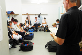 Fr Paul McDonald blesses and prays with riders before the first race at yesterday's twilight race meeting at Coffs Harbour. Fr Paul McDonald blesses and prays with riders before the first race at yesterday's twilight race meeting at Coffs Harbour.