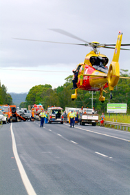 TRAGEDY ... A rescue helicopter lands on the Pacific Highway. TRAGEDY ... A rescue helicopter lands on the Pacific Highway.