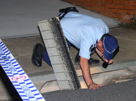 Police hunt ... NSW police officers look for clues near the Sussex Street address. PHOTO: FRANK REDWARD Police hunt ... NSW police officers look for clues near the Sussex Street address. PHOTO: FRANK REDWARD