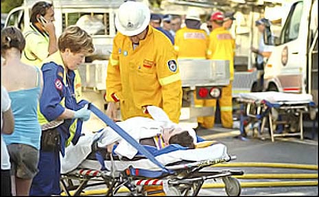 CHAOTIC SCENE: Emergency workers treat one of the injured people involved ina head-on collision. CHAOTIC SCENE: Emergency workers treat one of the injured people involved ina head-on collision.