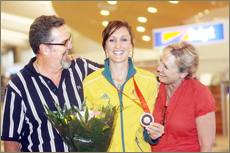 FAN CLUB: Rockhampton softball star and Olympic bronze medallist Kylie Cronk is welcomed home at Rockhampton Airport yesterday FAN CLUB: Rockhampton softball star and Olympic bronze medallist Kylie Cronk is welcomed home at Rockhampton Airport yesterday
