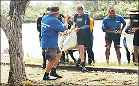 Trevor Long, of Sea World, and the rescue crew lift the mother dolphin from Prospect Lake. Trevor Long, of Sea World, and the rescue crew lift the mother dolphin from Prospect Lake.