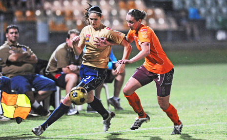 The Newcastle Jets Katie Gill, left, takes on Queensland Roar’s Karla Reuter during the W-League match at Oakes Oval, Lismore. The Newcastle Jets Katie Gill, left, takes on Queensland Roar’s Karla Reuter during the W-League match at Oakes Oval, Lismore.