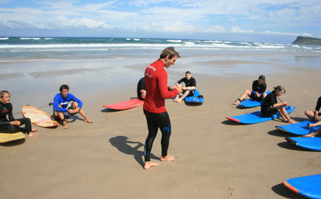 The Mojosurf students prepare to get into the water at Lennox Head on Thursday despite the beach being closed. The Mojosurf students prepare to get into the water at Lennox Head on Thursday despite the beach being closed.