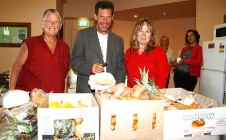 Liberation Larder organiser Honu Dawson (left) and volunteer Wendy Jagger (right) help Michael O’Hagen with a bag of free groceries. Liberation Larder organiser Honu Dawson (left) and volunteer Wendy Jagger (right) help Michael O’Hagen with a bag of free groceries.