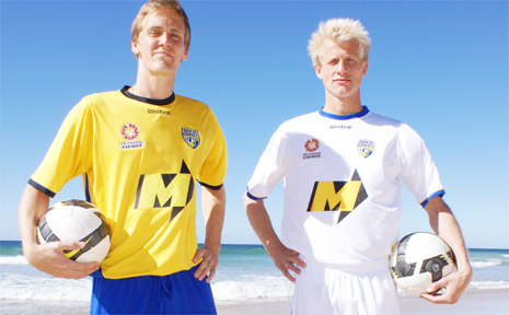 Players Michael Thwaite and Bas van den Brink model Gold Coast United’s home and away playing strips. Players Michael Thwaite and Bas van den Brink model Gold Coast United’s home and away playing strips.