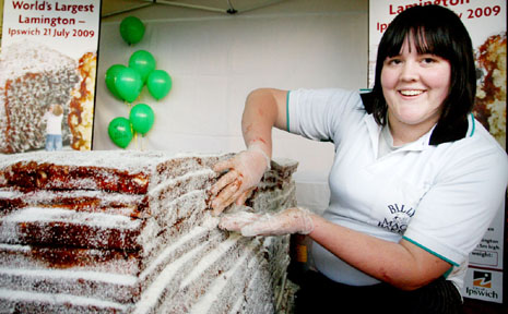 Billy Mac's bakery assistant Emily Dwyer puts the final touches on the world's largest lamington. Billy Mac's bakery assistant Emily Dwyer puts the final touches on the world's largest lamington.
