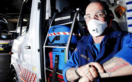 FIGHTING THE FLU: In a bid to help control the spread of swine flu, Lismore ambulance paramedic Bill Stralow is wearing the face mask and goggles now mandatory for all frontline ambulance workers in NSW. FIGHTING THE FLU: In a bid to help control the spread of swine flu, Lismore ambulance paramedic Bill Stralow is wearing the face mask and goggles now mandatory for all frontline ambulance workers in NSW.