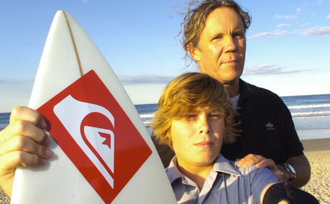 CLOSE SHAVE: Zac Skyring and his father Nigel, of Broken Head, show the damage to Zac’s wetsuit and the compression mark on his surfboard after his brush with a shark at Broken Head yesterday. CLOSE SHAVE: Zac Skyring and his father Nigel, of Broken Head, show the damage to Zac’s wetsuit and the compression mark on his surfboard after his brush with a shark at Broken Head yesterday.