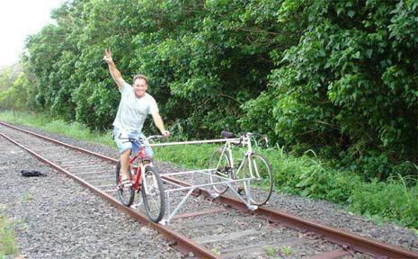 Julio Mottola rides his ‘locobike’ along a section of the unused rail line at Byron Bay. Julio Mottola rides his ‘locobike’ along a section of the unused rail line at Byron Bay.