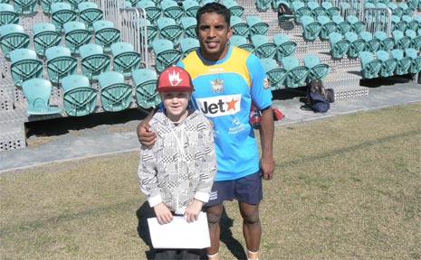 One of the young Red Devils, Judd Batson, is pictured with Titans player, Preston Campbell. One of the young Red Devils, Judd Batson, is pictured with Titans player, Preston Campbell.
