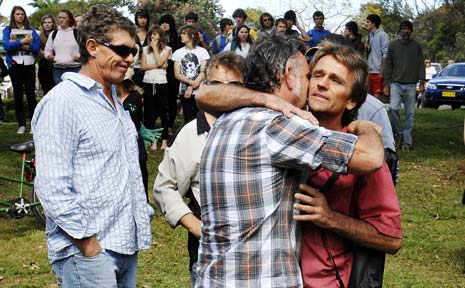 Jai Morcom’s father, Steve Drummond, right, is supported by friends and relatives during yesterday’s student walk-out at Mullumbimby. Jai Morcom’s father, Steve Drummond, right, is supported by friends and relatives during yesterday’s student walk-out at Mullumbimby.