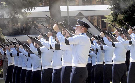 A special guard of airmen fires off a volley after the service. A special guard of airmen fires off a volley after the service.