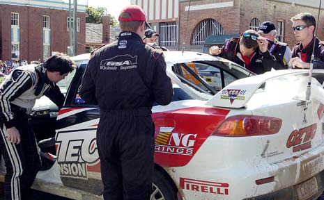 DAMAGE: Pit crew members look at the damage caused by a rock thrown through the back windscreen of the rally car driven by Steven Shepheard and co-driver John McCarthy. DAMAGE: Pit crew members look at the damage caused by a rock thrown through the back windscreen of the rally car driven by Steven Shepheard and co-driver John McCarthy.