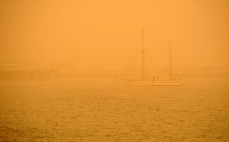 A yacht sailing into Coffs Harbour Jetty could barely be seen through the thick dust at around 9am this morning. A yacht sailing into Coffs Harbour Jetty could barely be seen through the thick dust at around 9am this morning.