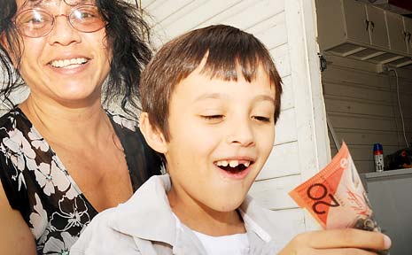 IT’S SAFE: Fiona Rutherford watches son Kyle, 8, put some birthday money into his piggy bank. IT’S SAFE: Fiona Rutherford watches son Kyle, 8, put some birthday money into his piggy bank.