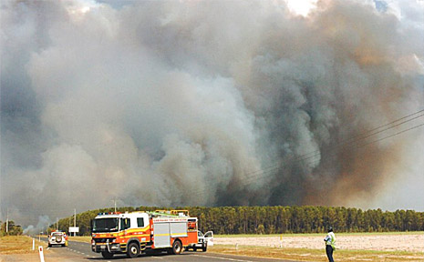 Boonooroo Road was closed for several hours yesterday as a fierce bushfire humped it, burning the pine forest in Tuan. Boonooroo Road was closed for several hours yesterday as a fierce bushfire humped it, burning the pine forest in Tuan.