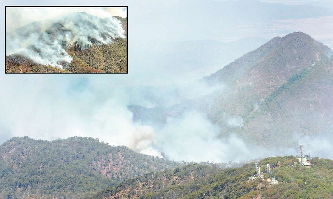 Plumes of smoke show the extent of fires close to the summit of Mount Archer (transmission towers in the foreground) yesterday. Difficult terrain and swirling winds hampered attempts to contain the fire's progress. Plumes of smoke show the extent of fires close to the summit of Mount Archer (transmission towers in the foreground) yesterday. Difficult terrain and swirling winds hampered attempts to contain the fire's progress.