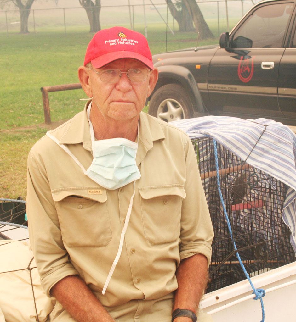 Ross Moore sits with his birds which he fled with. Ross Moore sits with his birds which he fled with.