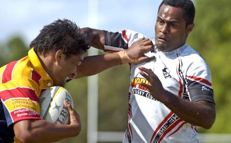Brackin Henry (left) fends off the Fijian defence in the Byron Bay Rugby Sevens men’s final yesterday. Brackin Henry (left) fends off the Fijian defence in the Byron Bay Rugby Sevens men’s final yesterday.