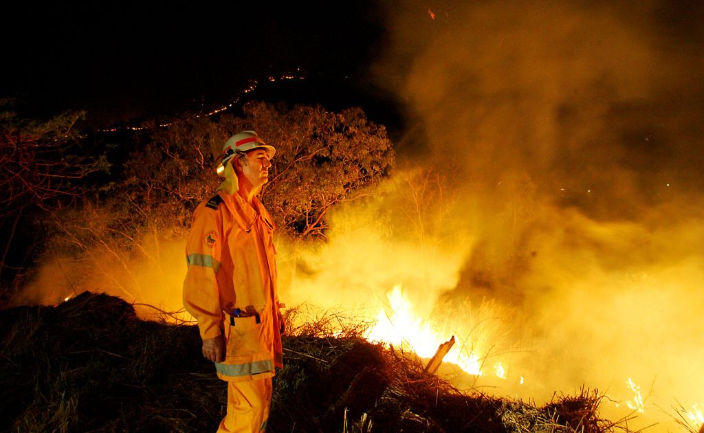 Crews back burn behind their Forbes Avenue home in Rockhampton. Crews back burn behind their Forbes Avenue home in Rockhampton.