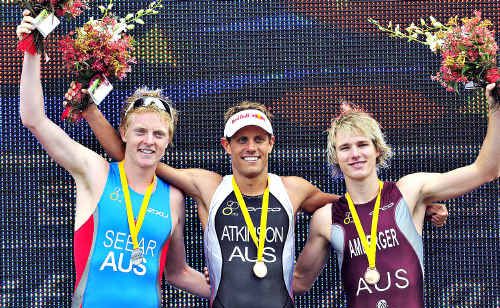 Noosa triathlon champion Courtney Atkinson, centre, is flanked by runner-up James Seear and third-place finisher Josh Amberger. Noosa triathlon champion Courtney Atkinson, centre, is flanked by runner-up James Seear and third-place finisher Josh Amberger.