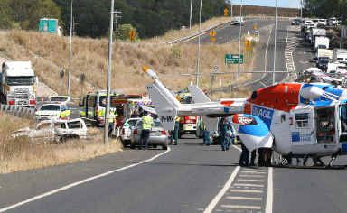 South-bound traffic on the Bruce Highway wait while injured passengers are loaded into a helicopter to be airlifted to hospital. South-bound traffic on the Bruce Highway wait while injured passengers are loaded into a helicopter to be airlifted to hospital.