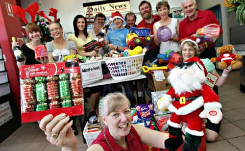 Tweed Daily News staff, with the hamper they collected last year for a needy family. Tweed Daily News staff, with the hamper they collected last year for a needy family.