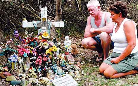 Peter and Robyn Stace at their daughter Lee Ellen's memorial grave site at Redcliff Beach. Peter and Robyn Stace at their daughter Lee Ellen's memorial grave site at Redcliff Beach.
