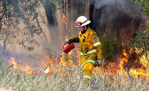 Firefighters work on containment lines as bushfires burn at Cabarita and Pottsville yesterday. Firefighters work on containment lines as bushfires burn at Cabarita and Pottsville yesterday.
