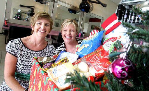 Strands Hairdressing owners Jeni Harvey and Bronwyn Galante have adopted two families this Christmas. Strands Hairdressing owners Jeni Harvey and Bronwyn Galante have adopted two families this Christmas.