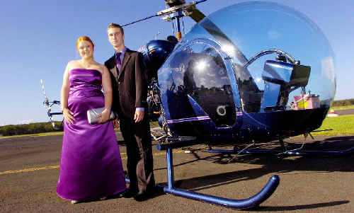 Ballina High School students Sharnie Flanagan-Boyd and Michael Loomes arrive at their Year 12 formal at Ballina RSL club by helicopter. Ballina High School students Sharnie Flanagan-Boyd and Michael Loomes arrive at their Year 12 formal at Ballina RSL club by helicopter.