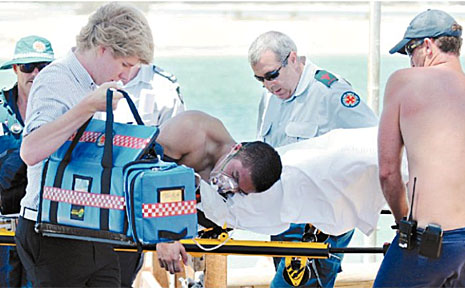 Ambulance officers treat a male Schoolies Week reveller, who owes his life to a Caloundra beachgoer and a lifeguard. Ambulance officers treat a male Schoolies Week reveller, who owes his life to a Caloundra beachgoer and a lifeguard.