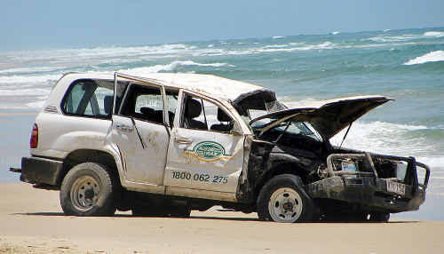 The wrecked 4WD after the rollover on Fraser Island yesterday when a Japanese tourist died. The wrecked 4WD after the rollover on Fraser Island yesterday when a Japanese tourist died.