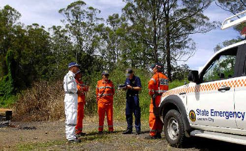Police and SES workers at the scene of the burnt-out vehicle (left) near Barkers Vale. Police and SES workers at the scene of the burnt-out vehicle (left) near Barkers Vale.