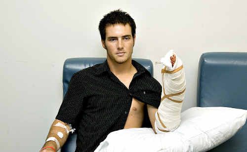 John Pengelly sits at the Royal Brisbane Hospital in Brisbane on Monday showing his heavily bandaged arm. John Pengelly sits at the Royal Brisbane Hospital in Brisbane on Monday showing his heavily bandaged arm.