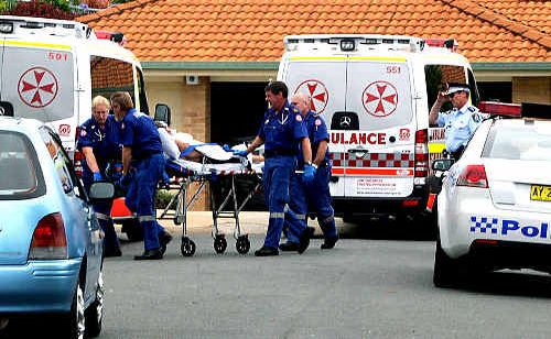 Ambulance officers wheel away a man assaulted at a Banora Point home yesterday. Ambulance officers wheel away a man assaulted at a Banora Point home yesterday.