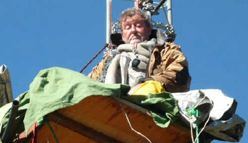 Australian farmer Peter Spencer perches on a platform up a steel wind monitoring towermast on his farm at Shannons Flat Australian farmer Peter Spencer perches on a platform up a steel wind monitoring towermast on his farm at Shannons Flat