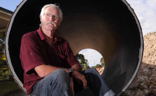 Sunshine Coast resident Rodger Shepherd sits inside an unused length of pipe on his property, part of a still-current plan to link Brisbane to the Mary River. Sunshine Coast resident Rodger Shepherd sits inside an unused length of pipe on his property, part of a still-current plan to link Brisbane to the Mary River.