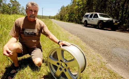 Wooli-Minnie Water Chamber of Commerce president Bruce Bird, pictured with a damaged car rim, is calling on council to fix the Wooli Road. Wooli-Minnie Water Chamber of Commerce president Bruce Bird, pictured with a damaged car rim, is calling on council to fix the Wooli Road.