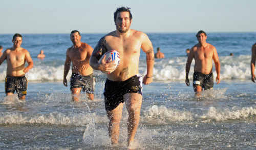 Grafton Ghosts new import Thomas Burnell enjoys the fun and the sun with teammates at Minnie Water yesterday. Grafton Ghosts new import Thomas Burnell enjoys the fun and the sun with teammates at Minnie Water yesterday.