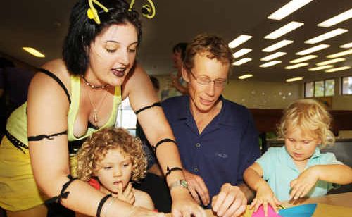 Library volunteer Kara Perring assists Sunnivar Goring, 4, and Andrew Black and his daughter Letitia, 4, all of Grafton, with an origami project. Library volunteer Kara Perring assists Sunnivar Goring, 4, and Andrew Black and his daughter Letitia, 4, all of Grafton, with an origami project.
