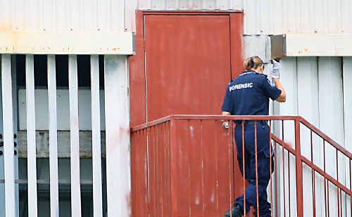 A police forensics officer examines an entrance to Hegvold Stadium yesterday. A police forensics officer examines an entrance to Hegvold Stadium yesterday.